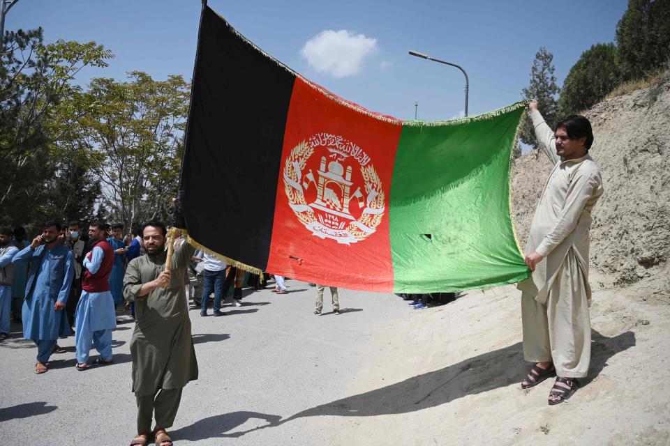 Afghans celebrate the 102nd Independence Day of Afghanistan with the national flag in Kabul on Aug. 19, 2021.