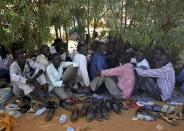 Internally displaced men sit inside a United Nations Missions in Sudan (UNMIS) compound in Juba December 19, 2013. South Sudanese government troops battled to regain control of a flashpoint town and sent forces to quell fighting in a vital oil producing area on Thursday, the fifth day of a conflict that that has deepended ethnic divisions in the two-year-old nation. REUTERS/Goran Tomasevic (SOUTH SUDAN - Tags: POLITICS CIVIL UNREST)