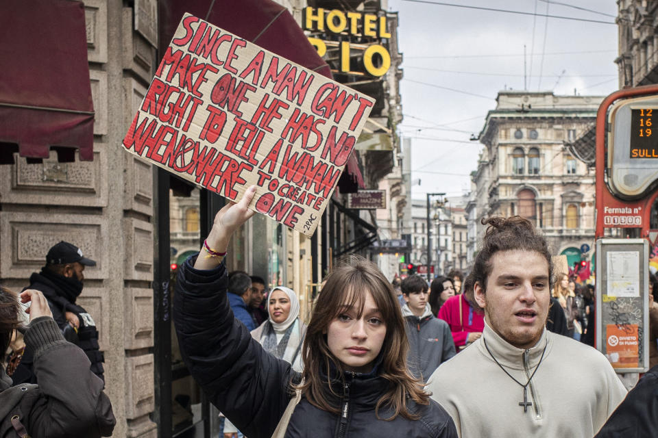 A woman holds up a sign denouncing violence against women during a march on the occasion of International Women's Day, in Milan, Italy, Friday, March 8, 2024. Marches, demonstrations and conferences are being held the world over, from Asia to Latin America and elsewhere to mark International Women’s Day. (Marco Ottico/LaPresse via AP)