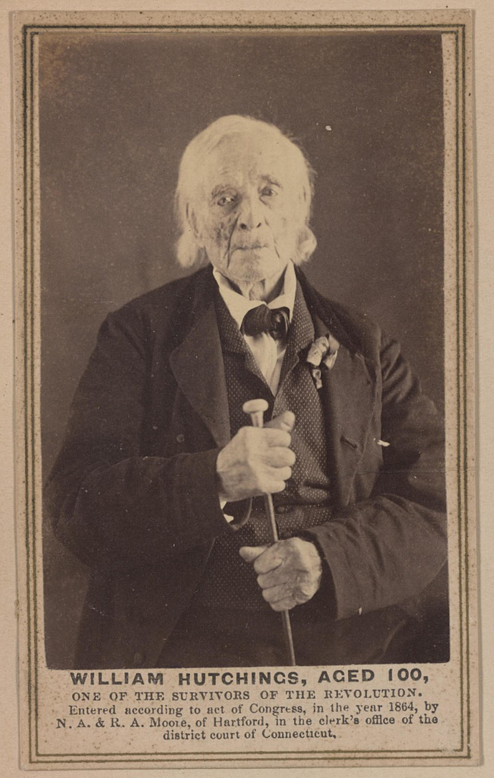 He's 100 in the portrait and looks very old, with some white, longish hair and wearing a suit, vest, and bow tie, with caption "William Hutchings, aged 100, one of the survivors of the revolution; entered according to act of Congress in the year 1864"