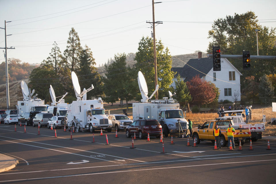 Media vehicles line the road near Umpqua Community College on October 2, 2015 in Roseburg, Oregon. &nbsp;Yesterday 10 people were killed and another seven were wounded on the campus when 26-year-old Chris Harper Mercer went on a shooting rampage.&nbsp;