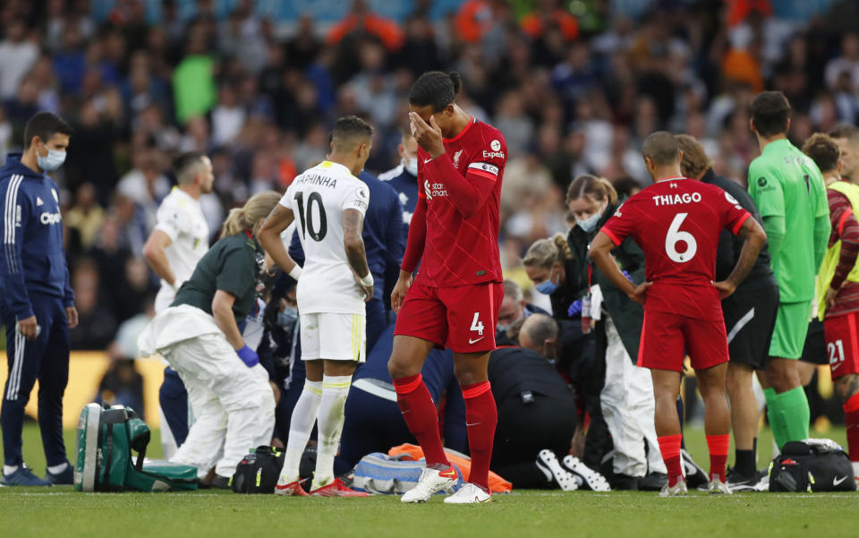 Liverpool's Virgil van Dijk reacts as Harvey Elliott receives medical attention after sustaining an injury. 