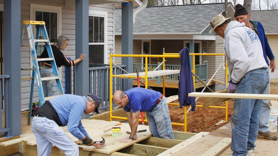 ASHEVILLE, NORTH CAROLINA, USA - APRIL 3, 2008: Volunteers for the nonprofit organization Habitat for Humanity work building new energy efficient houses for low income partner families in Asheville.