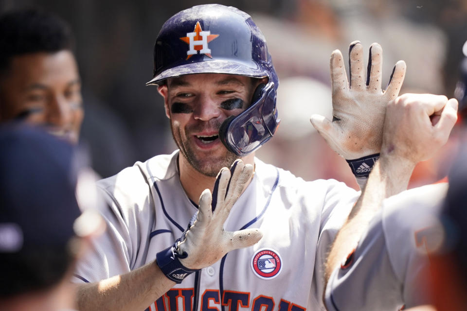 Houston Astros' Chas McCormick is congratulated by teammates after hitting a two-run home run in the sixth inning of a baseball game against the Cleveland Indians, Sunday, July 4, 2021, in Cleveland. (AP Photo/Tony Dejak)