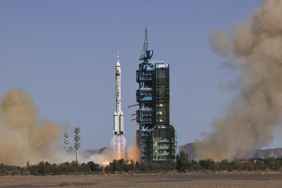 In this photo released by Xinhua News Agency, the Long March-2F carrier rocket carrying China's Shenzhou 14 spacecraft blasts off from the launch pad at the Jiuquan Satellite Launch Center in Jiuquan, northwest China's Gansu Province, Sunday, June 5, 2022. China on Sunday launched the new three-person mission to complete work on its permanent orbiting space station. (Li Gang/Xinhua via AP)