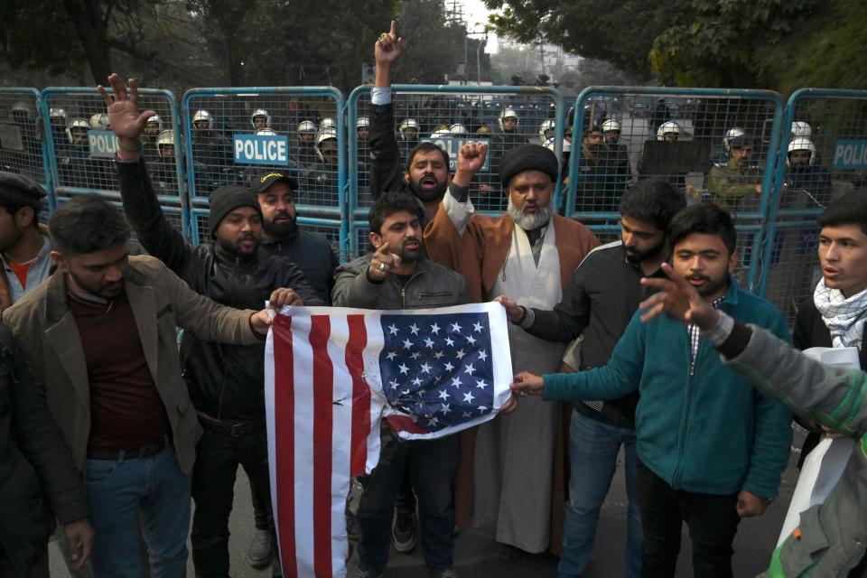 Protesters in Lahore, Pakistan, hold a burned American flag and shout slogans near the U.S. consulate after the assassination of Soleimani in Iraq. (Photo: ARIF ALI via Getty Images)