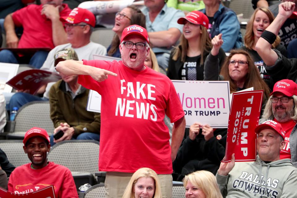 Supporters react as U.S. President Donald Trump speaks during a 