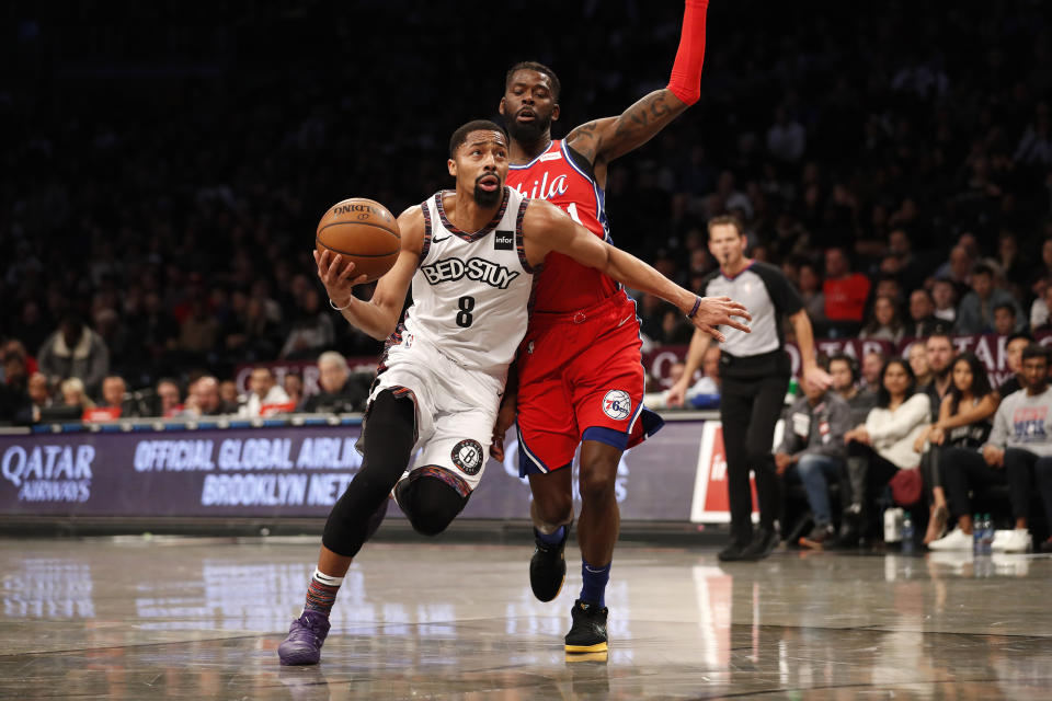Brooklyn Nets guard Spencer Dinwiddie (8) drives against Philadelphia 76ers forward James Ennis III during the second quarter of an NBA basketball game at Barclays Center, Sunday, Dec. 15, 2019, in New York. (AP Photo/Michael Owens)