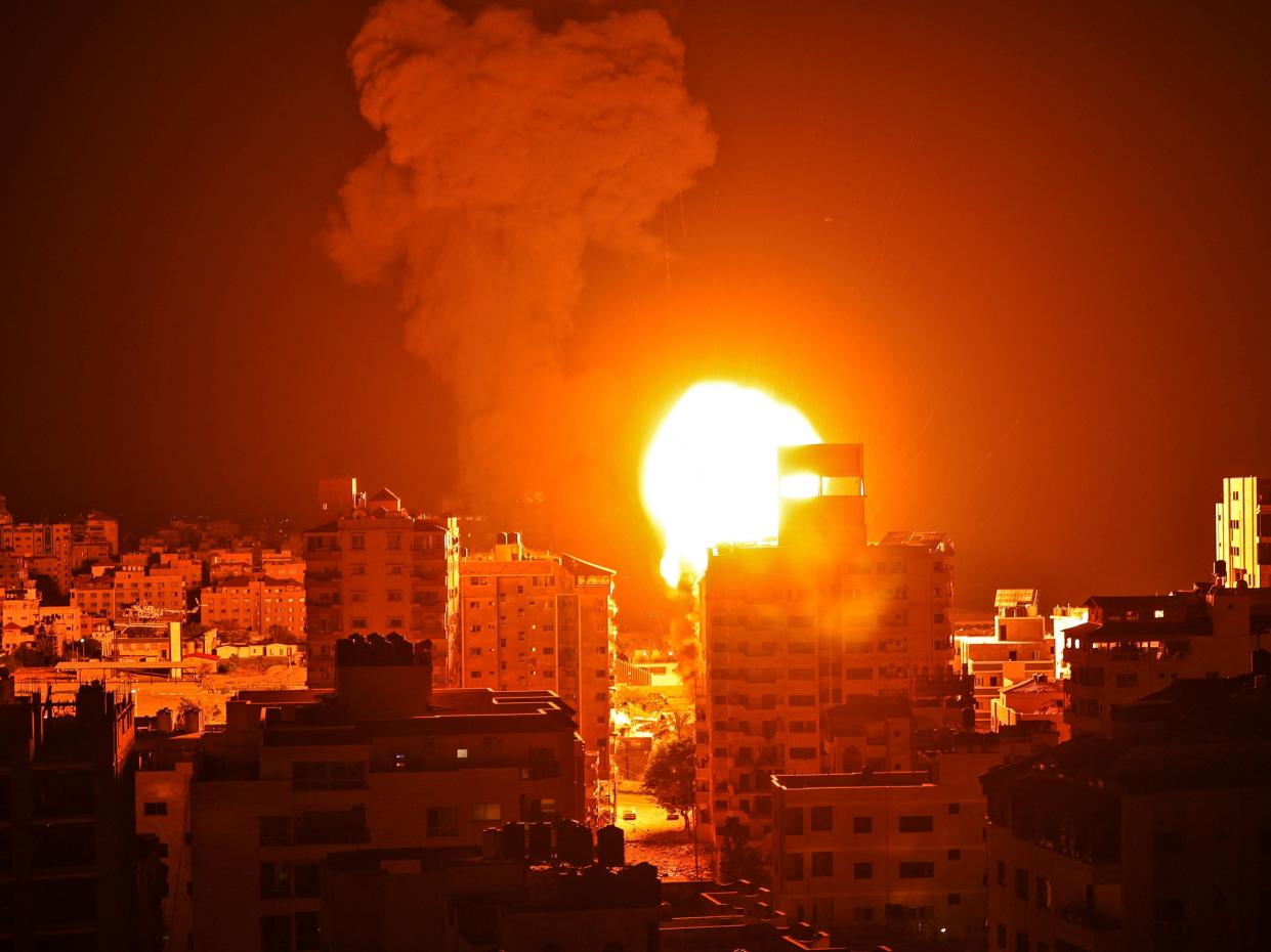 <p>An Israeli airstrike on Gaza City during the early hours of Monday</p> (AFP)