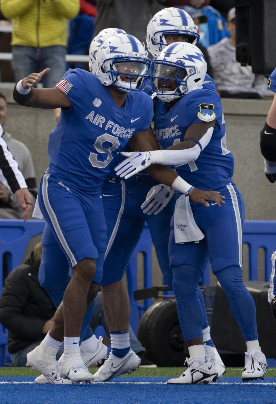 Air Force quarterback Zac Larrier (9) celebrates with running back John Lee Eldridge III (24) after scoring against Utah State during the first half of an NCAA college football game in Air Force Academy, Colo., Friday, Sept. 15, 2023. | Christian Murdock/The Gazette via AP