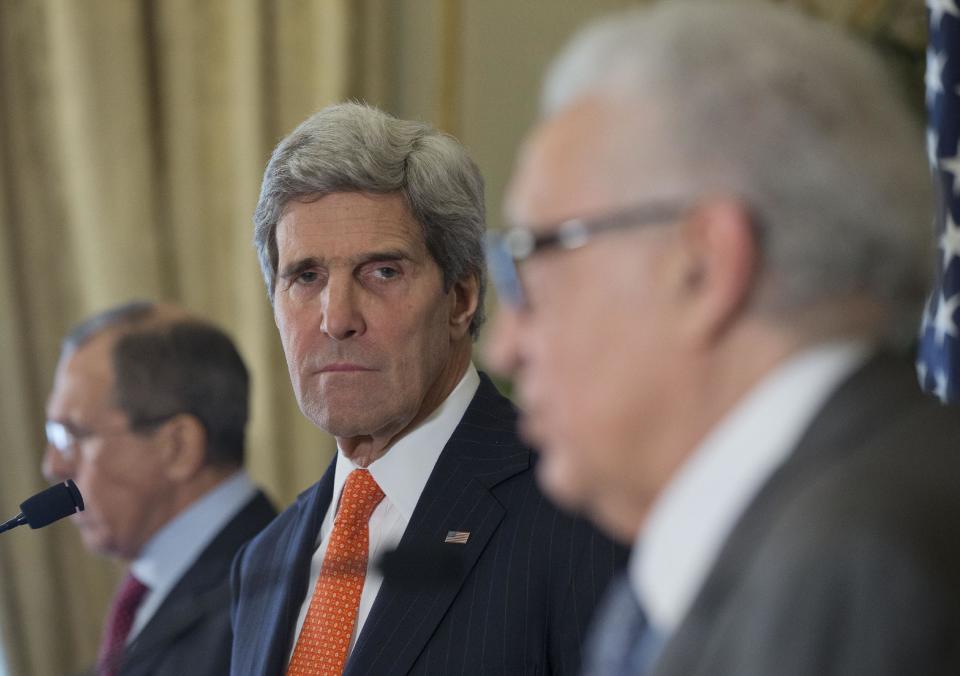 US Secretary of State John Kerry, center, with Russia's Foreign Minister Sergey Lavrov, left, and U.N-Arab League envoy for Syria Lakhdar Brahimi, right, attend a joint news conference at the US Ambassador's residence in Paris, France, Monday, Jan. 13, 2014. Kerry is in Paris for meetings on Syria to rally international support for ending the three-year civil war in Syria. (AP Photo/Pablo Martinez Monsivais, Pool)