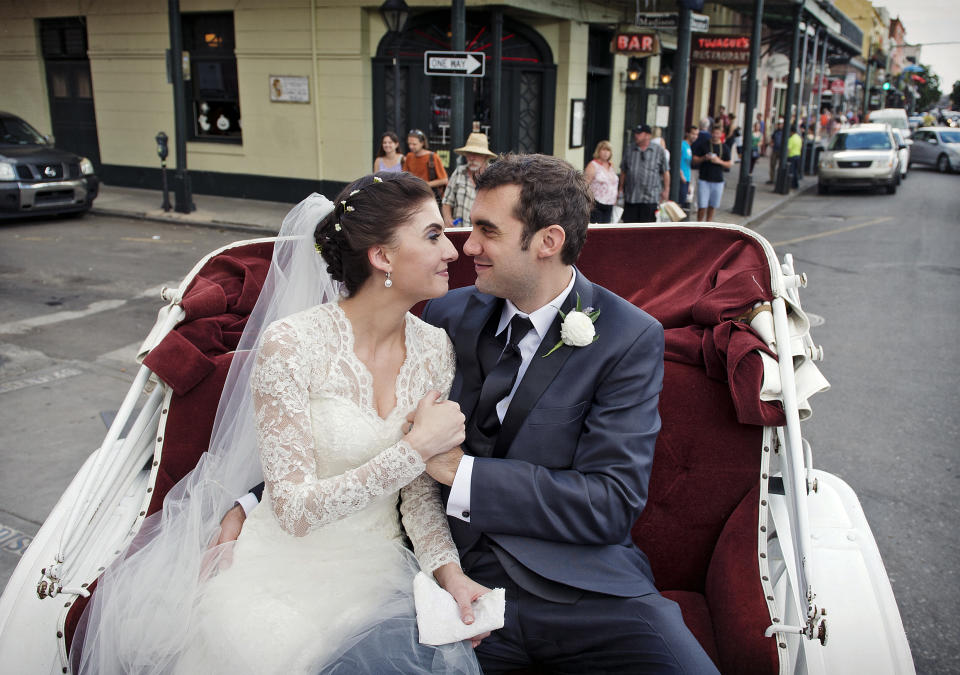 This Oct. 12, 2013 photo provided by Julia Bailey shows Shannon and Justin Peach, riding in a carriage after their wedding in New Orleans. Shannon's mom, Cheryl Winter, spent $500 for Hartford-based Travelers Insurance to cover her daughter’s destination wedding, where her biggest concern was a potential hurricane. The weather cooperated, but after the limousine failed to show they used the insurance policy to claim the deposit money they could not get back from the limo driver. (AP Photo/Julia Bailey)