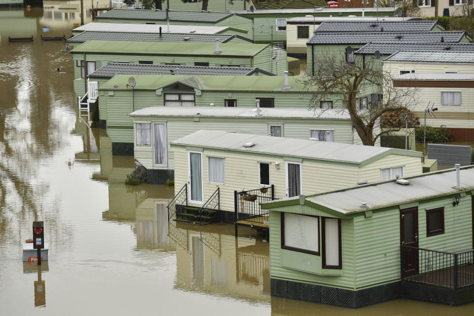 The Riverside Caravan Park is inundated by flood water after heavy rains breached the nearby river Severn and normal watercourses in the area of Bridgnorth, England, Wednesday Feb. 19, 2020. Flood-hit communities are braced for further heavy rain as river levels continue to threaten to breach barriers, in the aftermath of Storm Dennis which has swept northern Europe. (Jacob King/PA via AP)