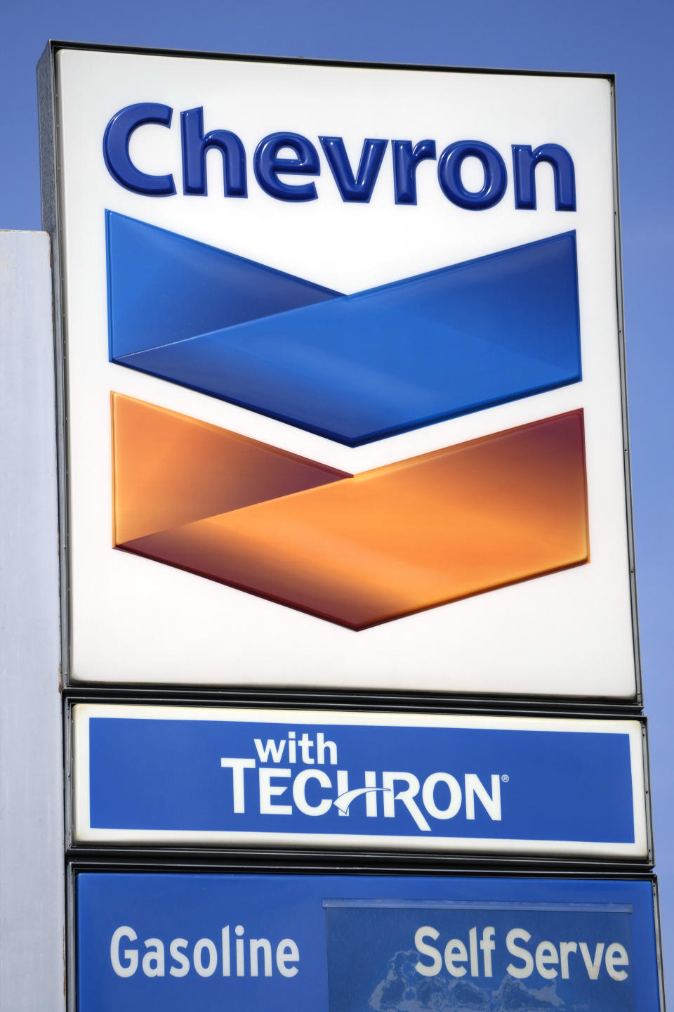 A Chevron logo rides adjacent to a gas station-convenience store in Columbus, Miss., Monday, Oct. 23, 2023. Chevron is buying Hess Corp. for $53 billion as major producers seize the initiative while oil prices surge. (AP Photo/Rogelio V. Solis)