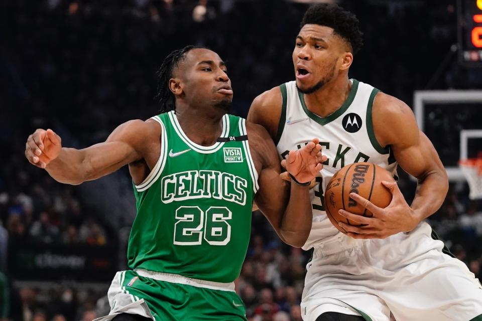 Milwaukee Bucks' Giannis Antetokounmpo drives past Boston Celtics' Aaron Nesmith during the first half of an NBA basketball game Thursday, April 7, 2022, in Milwaukee. (AP Photo/Morry Gash)