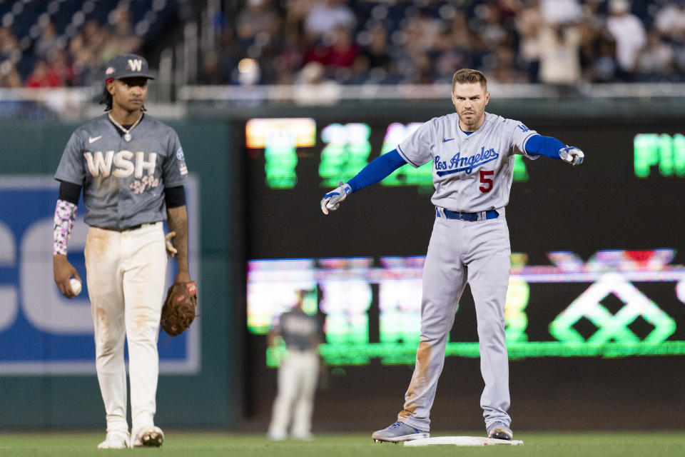 Los Angeles Dodgers' Freddie Freeman, right, celebrates next to Washington Nationals shortstop CJ Abrams, left, after hitting a double during the fifth inning of a baseball game, Friday, Sept. 8, 2023, in Washington. (AP Photo/Stephanie Scarbrough)