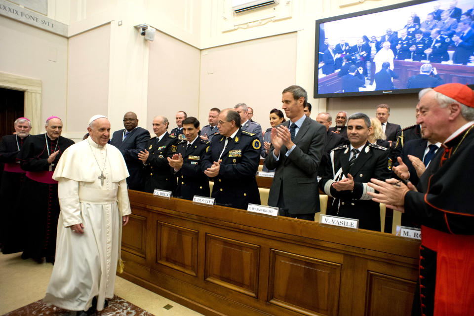 In this photo released by Vatican newspaper L'Osservatore Romano Pope Francis arrives at a conference about the human trafficking, at the Vatican, Thursday, April 10, 2014. Pope Francis has denounced human trafficking as a crime against humanity after meeting with four women who were forced into prostitution. Francis attended a Vatican conference Thursday of church workers, charity representatives and police chiefs from 20 nations, who pledged greater cooperation to encourage victims of trafficking and slavery to come forward. (AP Photo/L'Osservatore Romano)