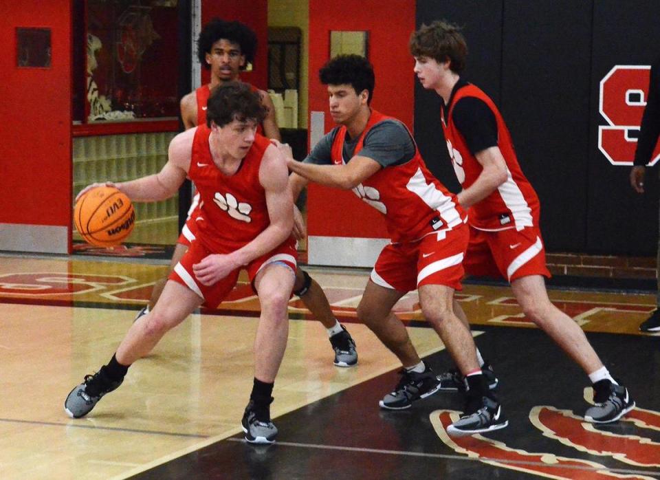 The South Meck Sabres, led by #23, Peter Moye (left with ball), a senior guard, are 13-0 this season They face off against, 4A power, Richmond, on Saturday. Head Coach Chris McDonald led the team through practice Wednesday, Jan. 3, 2024.