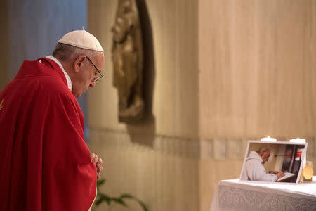 Pope Francis prays in front of a picture of Father Jacques Hamel during a mass in his memory at the Vatican, September 14, 2016. Osservatore Romano/ Handout via REUTERS