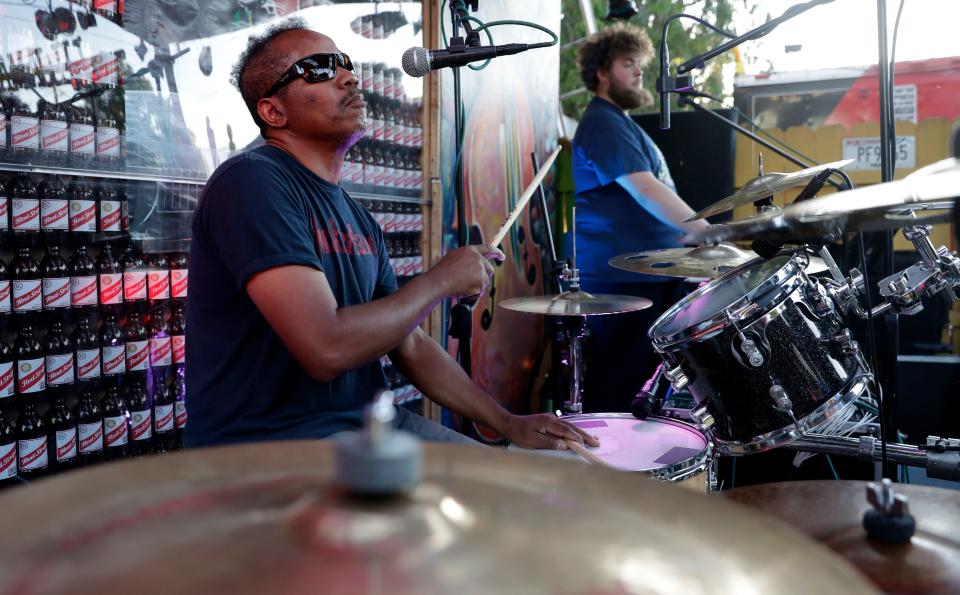 Drummer Kelvin Ayres keeps the beat during a performance by Unity the Band in June at Lil Jamaica in Green Bay. The popular reggae group plays some 120 shows during Wisconsin's outdoor music season.