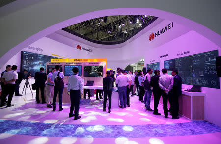 People visit Huawei's booth at an exhibition during the World Intelligence Congress in Tianjin, China May 16, 2019. REUTERS/Jason Lee