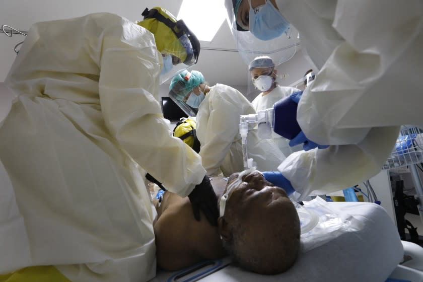 HOUSTON, TEXAS-JULY 1, 2020-Medical students under the direction of Dr. Jospeh Varon at United Memorial Medical Center work to revive COVID-19 patient Terry Hill, 65, after his heart stopped while he was being placed on a ventilator on Wednesday, July 1, 2020. At United Memorial Medical Center in Houston, Texas, Dr. Joseph Varon leads a team to fight the increasing number of coronavirus patients in the expanded Covid-19 ward on July 1, 2020. (Carolyn Cole/Los Angeles Times)