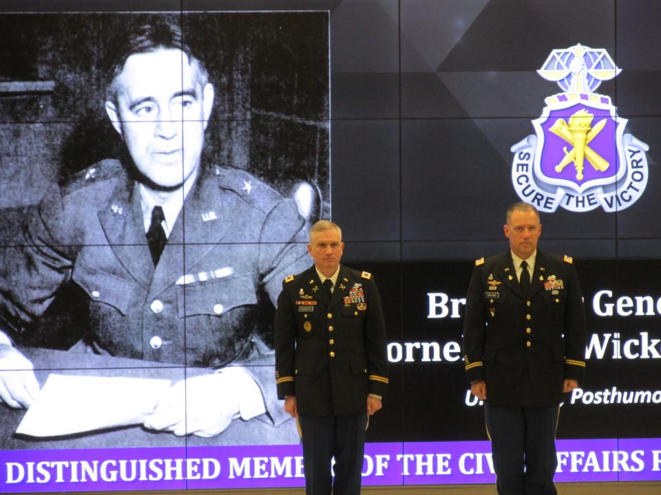 Brig. Gen. Cornelius Wickersham, represented by Lt. Col. Chad Hutchins, is recognized by Col. Charles Burnett as a distinguished member of the civil affairs regiment during a Nov. 4, 2021, ceremony at Fort Bragg.