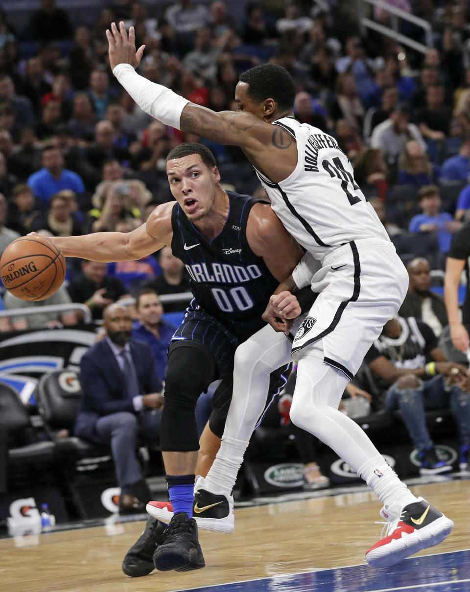 Orlando Magic's Aaron Gordon (00) moves around Brooklyn Nets' Rondae Hollis-Jefferson during the first half of an NBA basketball game Friday, Jan. 18, 2019, in Orlando, Fla. (AP Photo/John Raoux)