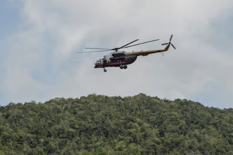 A Malaysian search and rescue helicopter flies near the Malaysia-Thailand border in Wang Kelian on May 28, 2015