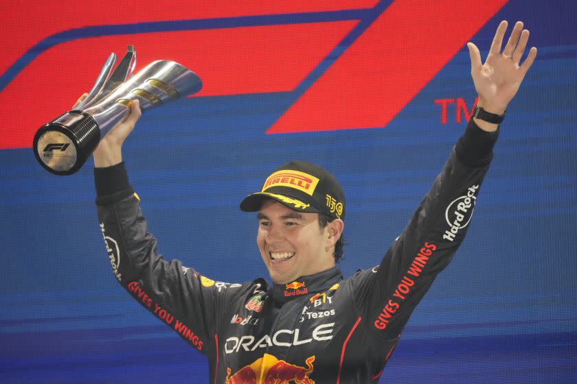 Red Bull driver Sergio Perez of Mexico celebrates after winning the Singapore Formula One Grand Prix, at the Marina Bay City Circuit in Singapore, Sunday, Oct. 2, 2022. (AP Photo/Vincent Thian)