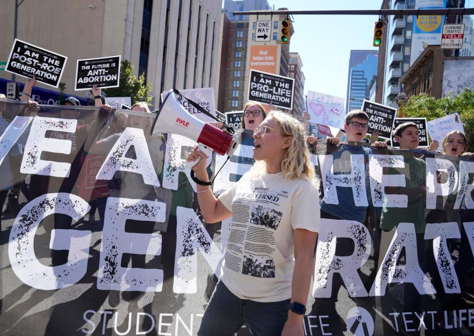 Jamie Scherdin of Columbus, the Ohio Regional Coordinator for Students for Life of America, leads a chant as thousands marched though downtown Columbus during the first Ohio March for Life on Wednesday. Barbara Perenic/Columbus Dispatch