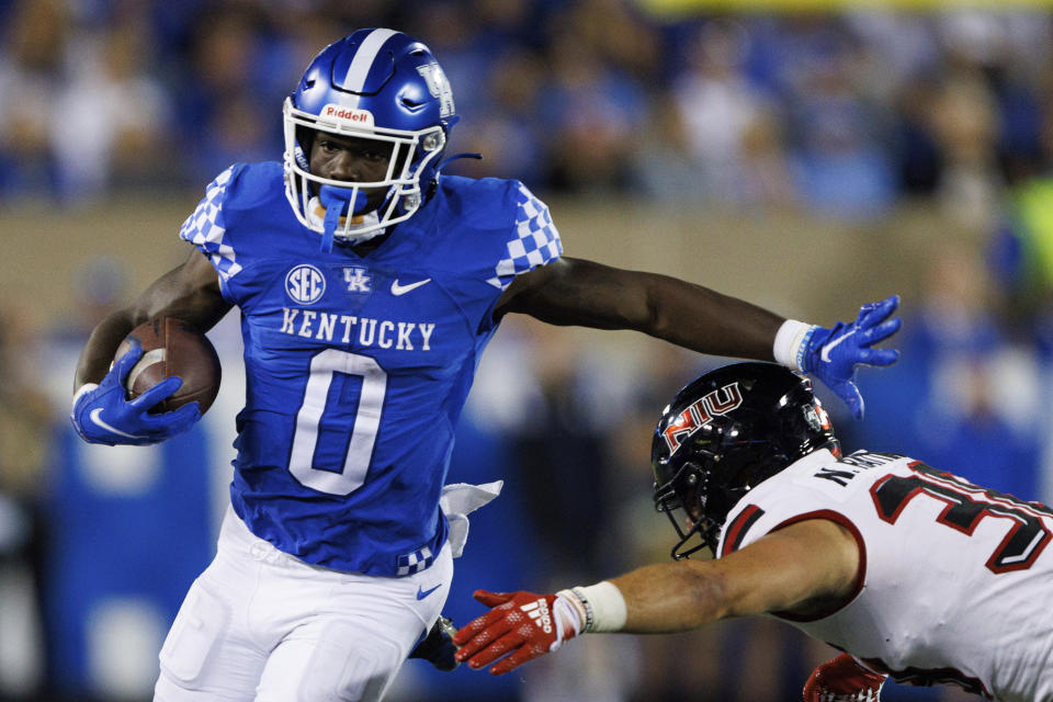 Kentucky running back Kavosiey Smoke (0) stiff-arms Northern Illinois linebacker Nick Rattin (38) during the second half of an NCAA college football game in Lexington, Ky., Saturday, Sept. 24, 2022. (AP Photo/Michael Clubb)