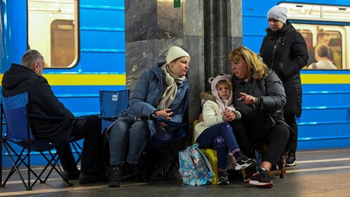 People take shelter inside a metro station during massive Russian missile attacks in Kyiv