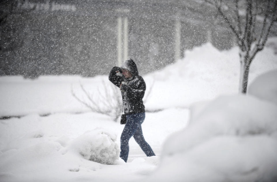 A pedestrian caught in Monday's blizzard like conditions in the Sierra Nevada, makes her way along Dorsey Drive, Feb. 27, 2023. Between eight and twelve inches of snowfall accumulation could be measured throughout the western locations of Nevada County. (Elias Funez/The Union via AP)
