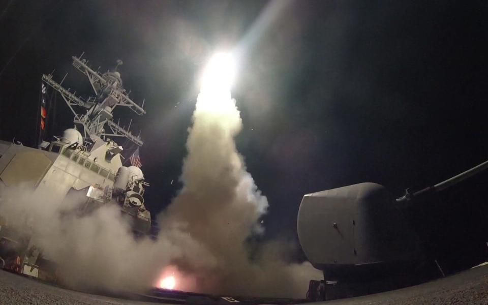 The USS Porter (DDG 78) fires a tomahawk land attack missile from the Mediterranean Sea after the April chemical attack - Credit: PA