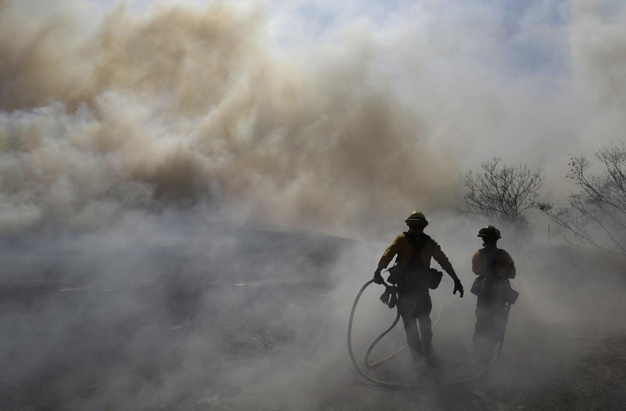 <span class="caption">New research shows that exposure to air pollution, including wildfire smoke, can make coronavirus particularly deadly.</span> <span class="attribution"><a class="link " href="http://apimages.com" rel="nofollow noopener" target="_blank" data-ylk="slk:AP Photo/Marcio Jose Sanchez;elm:context_link;itc:0;sec:content-canvas">AP Photo/Marcio Jose Sanchez</a></span>