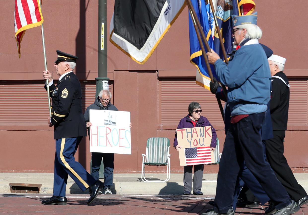 Lloyd Lewis and his wife Mary Lewis  show their support during the Veterans Day parade as it marches from Corktown down Michigan Ave. on Sunday, Nov. 7, 2021.