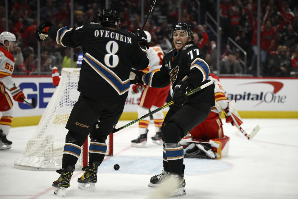 Washington Capitals right wing T.J. Oshie (77) celebrates his goal with left wing Alex Ovechkin (8) during the first period of an NHL hockey game against the Calgary Flames, Friday, Nov. 25, 2022, in Washington. (AP Photo/Nick Wass)