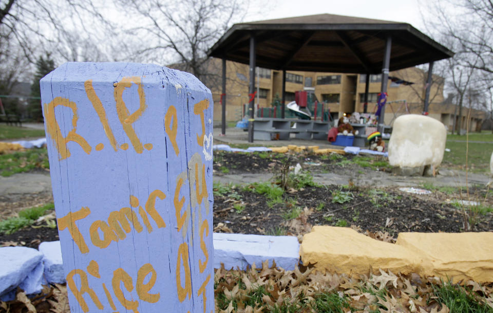 FILE- In this Dec. 29, 2015, file photo, "R.I.P. Tamir Rice" is written on a block of wood near a memorial for Rice outside the Cudell Recreation Center in Cleveland. The gazebo where 12-year old Rice was fatally shot by a white policeman in Cleveland is being rebuilt in Chicago as a temporary memorial and meeting spot. (AP Photo/Tony Dejak, File)