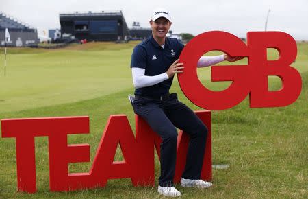 Golf-British Open - England's Justin Rose poses with the Team GB logo after being unveiled as part of Britain's Olympic Team - Royal Troon, Scotland, Britain - 13/07/2016. REUTERS/Russell Cheyne