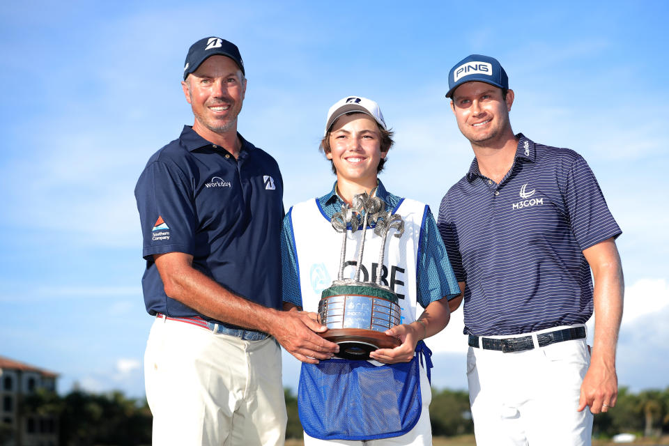 Harris English of the United States and Matt Kuchar of the United and his caddie and son Cameron Kuchar celebrate with the trophy after winning on the 18th green during the final round of the QBE Shootout at Tiburon Golf Club on December 13, 2020, in Naples, Florida. (Photo by Cliff Hawkins/Getty Images)