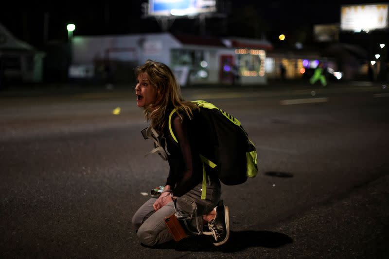 A demonstrator tries to confront the police on the 100th consecutive night of protests against police violence and racial inequality, in Portland, Oregon