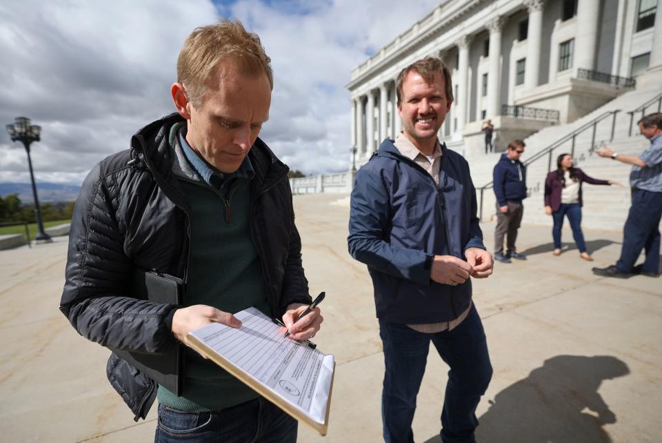 Mark Nielson signs a Utah Forward Party political party registration petition outside of the Capitol in Salt Lake City on Wednesday, Oct. 11, 2023. The Utah Forward Party has collected more than 2,000 petition signatures, which is required to put the party on voting ballots. | Kristin Murphy, Deseret News