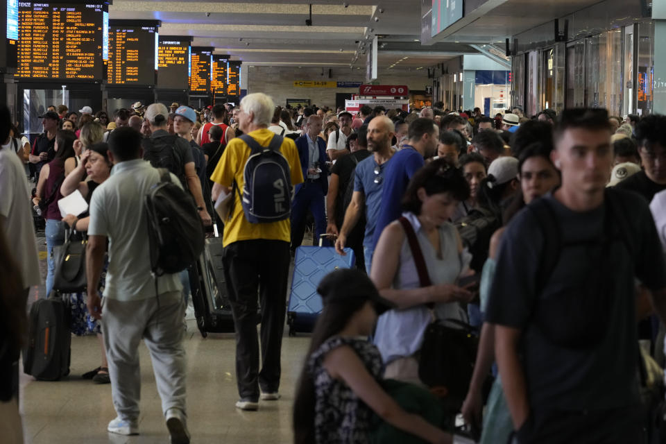 Passengers wait for their trains at Rome's termini central station during a national train strike, Thursday, July 13, 2023. Trenitalia and Italo train workers are on strike to demand better working conditions and training. (AP Photo/Gregorio Borgia)