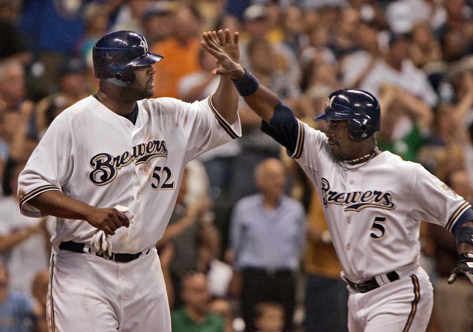 Milwaukee Brewers' CC Sabathia and Ray Durham celebrate after scoring on J.J. Hardy's hit in the 4th inning against the Houston Astros' at Miller Park Monday, August 18, 2008.