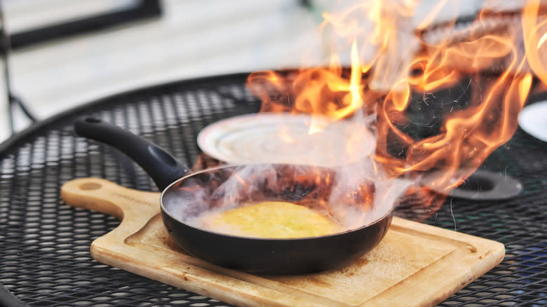 Flaming saganaki cheese in a pan
