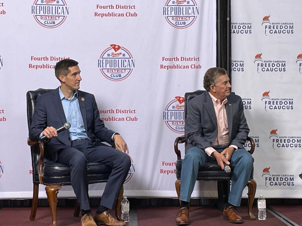 Rep. Adam Morgan, Former Sen. Jim DeMint listen to State Freedom Caucus Network President Andrew Roth speak at Freedom Caucus forum on April 3, 2023