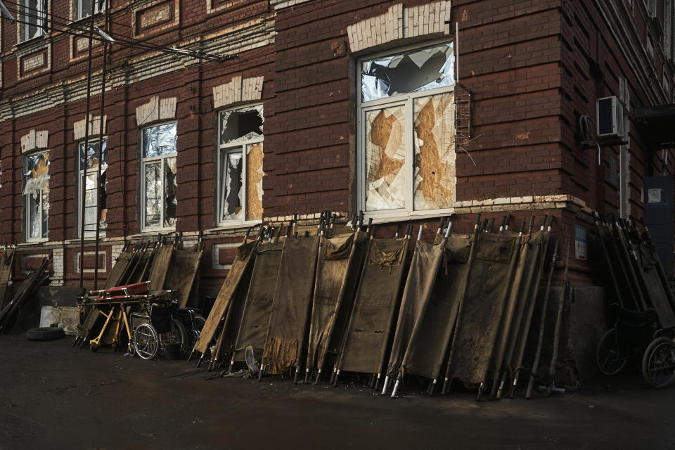 FILE - Stretchers are seen outside a city hospital, where wounded Ukrainian soldiers are brought for treatment, in Bakhmut, the site of heavy battles with Russian troops, in the Donetsk region, Ukraine, Friday, Dec. 9, 2022. (AP Photo/LIBKOS, File)