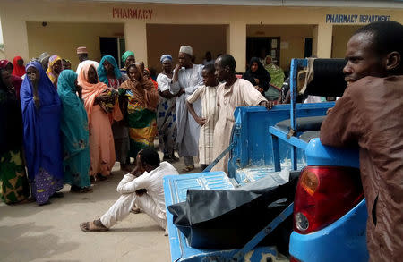 A man reacts as dead bodies are brought to a hospital after a suspected Boko Haram attack on the edge of Maiduguri's inner city, Nigeria April 2, 2018. REUTERS/Ahmed Kingimi