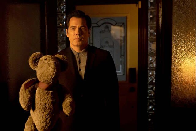 Luke Roman (Tim Rozon) holds a teddy bear in SurrealEstate 201 